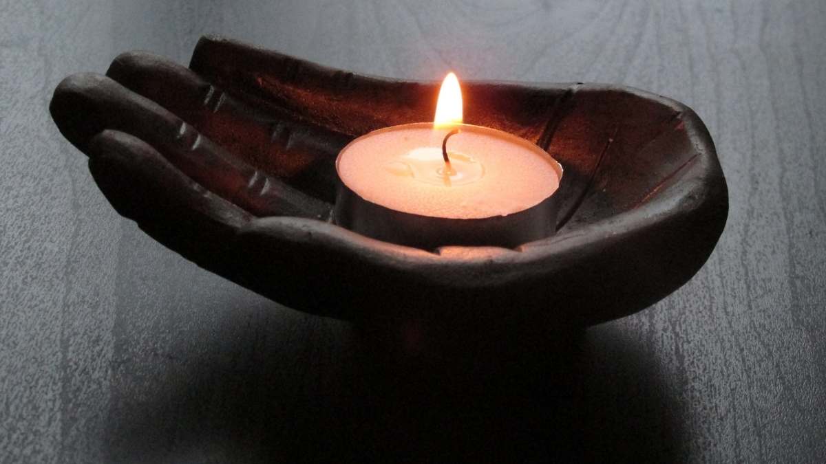 candle in ceramic hand peaceful