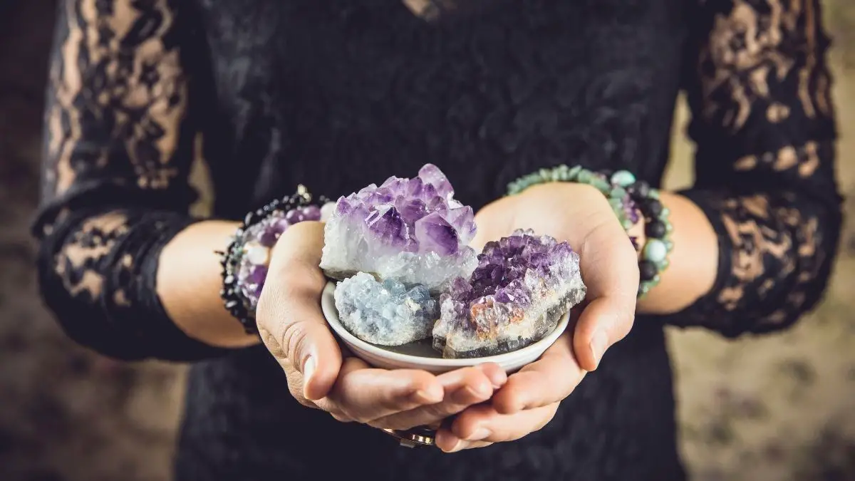lady holding a bowl of cleansed crystals
