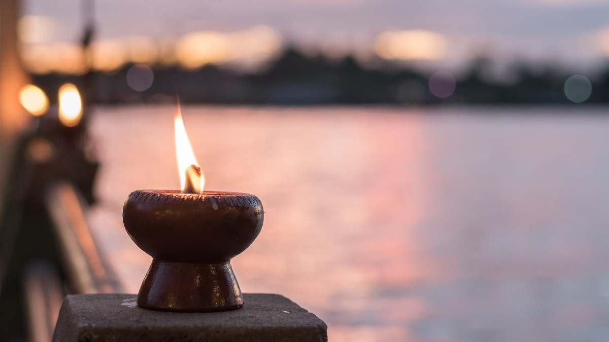 spiritual candle near body of water relaxing flame