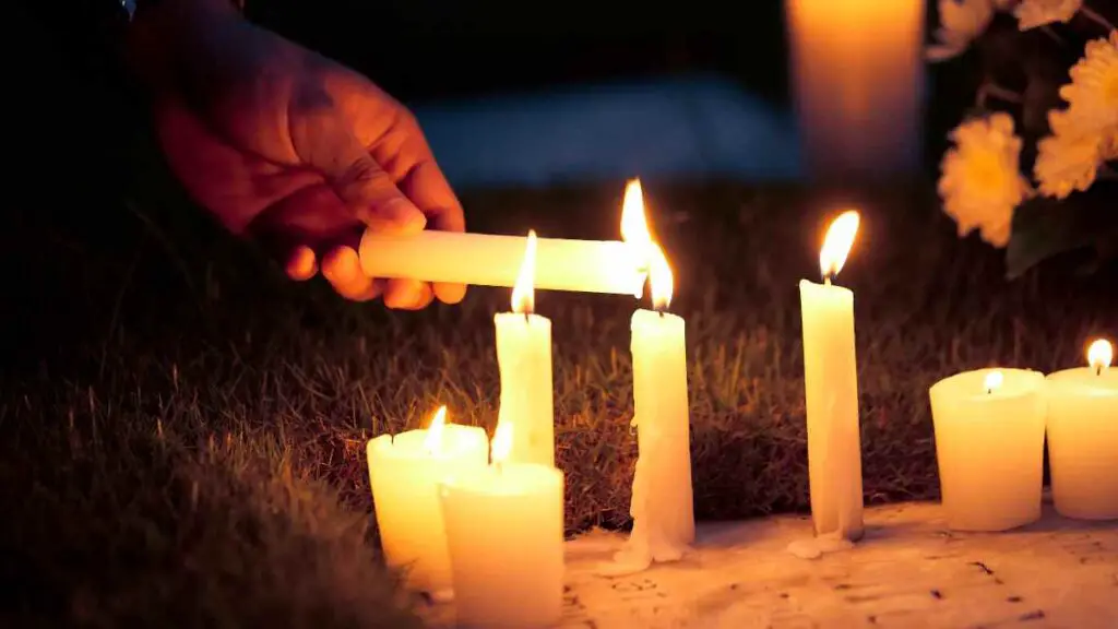 person lighting a candle