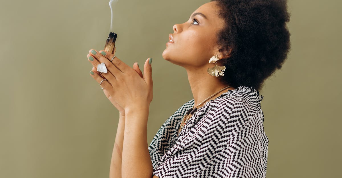 Woman in Black and White Stripe Shirt Smoking Cigarette