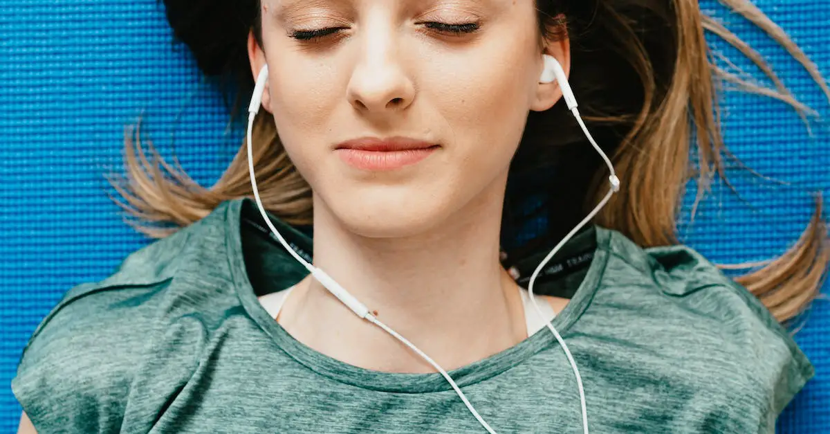 Young woman listening to music in earphones in apartment 6